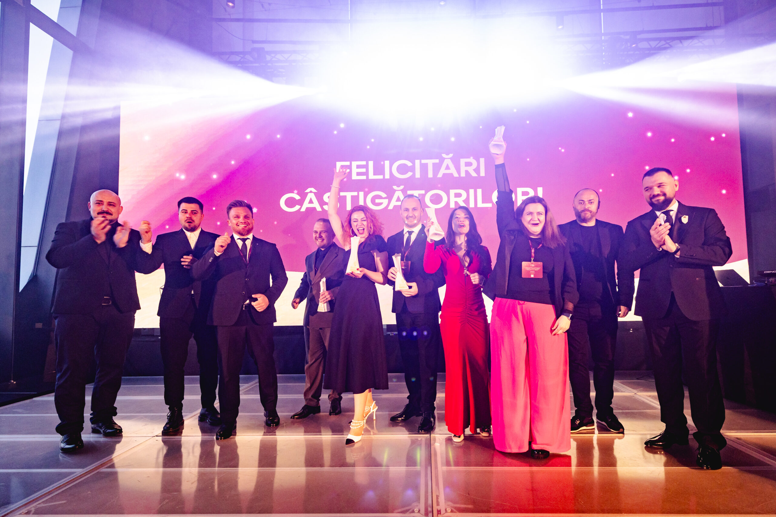 The image depicts the winners of Romanian competition Shop of the Year.